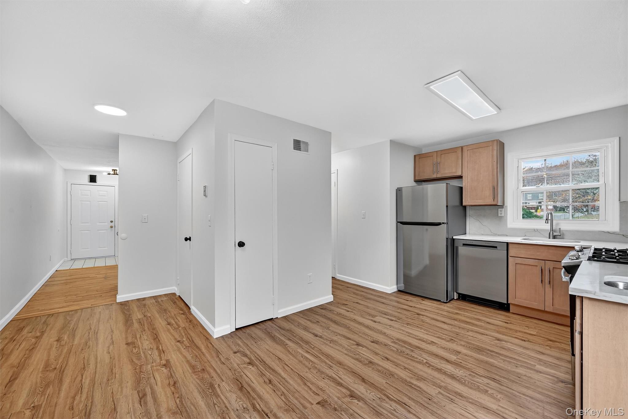 28 Alan Road Spring Valley, NY 10977 - Photo 11 of 39 a kitchen with a refrigerator and wooden floor