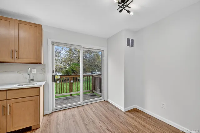 a view of a storage and utility room with wooden floor
