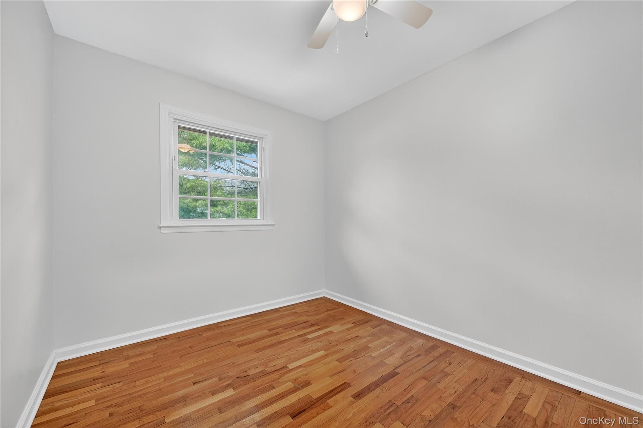 28 Alan Road Spring Valley, NY 10977 - Photo 15 of 39 wooden floor in an empty room with a window