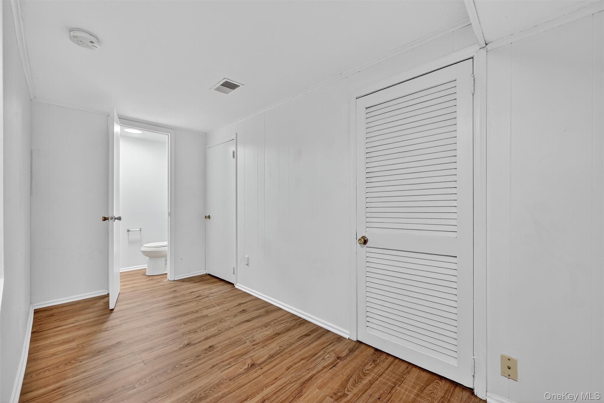 28 Alan Road Spring Valley, NY 10977 - Photo 30 of 39 a view of a room with wooden floor and white walls