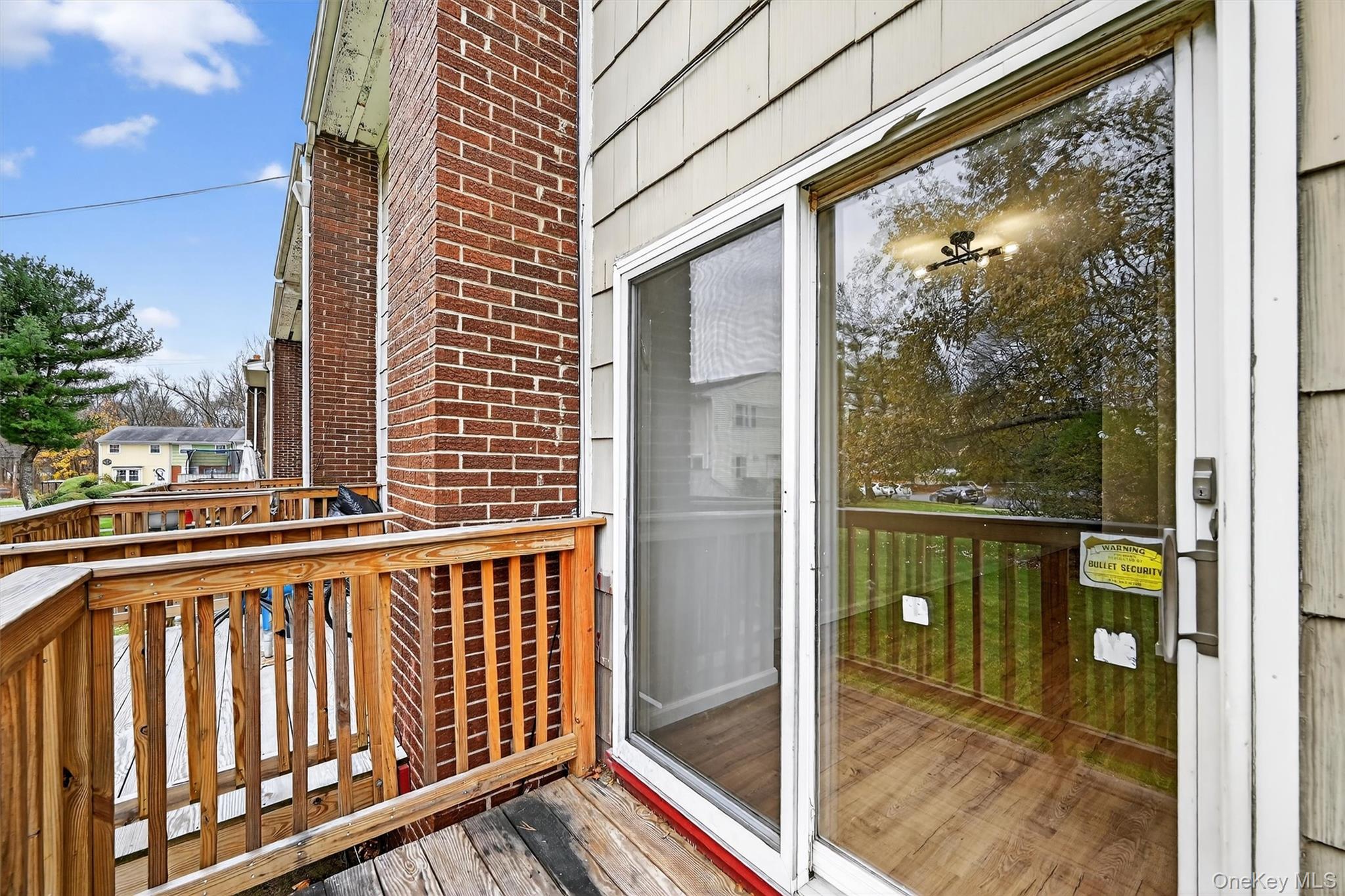 28 Alan Road Spring Valley, NY 10977 - Photo 34 of 39 a view of a balcony with floor to ceiling windows with wooden floor