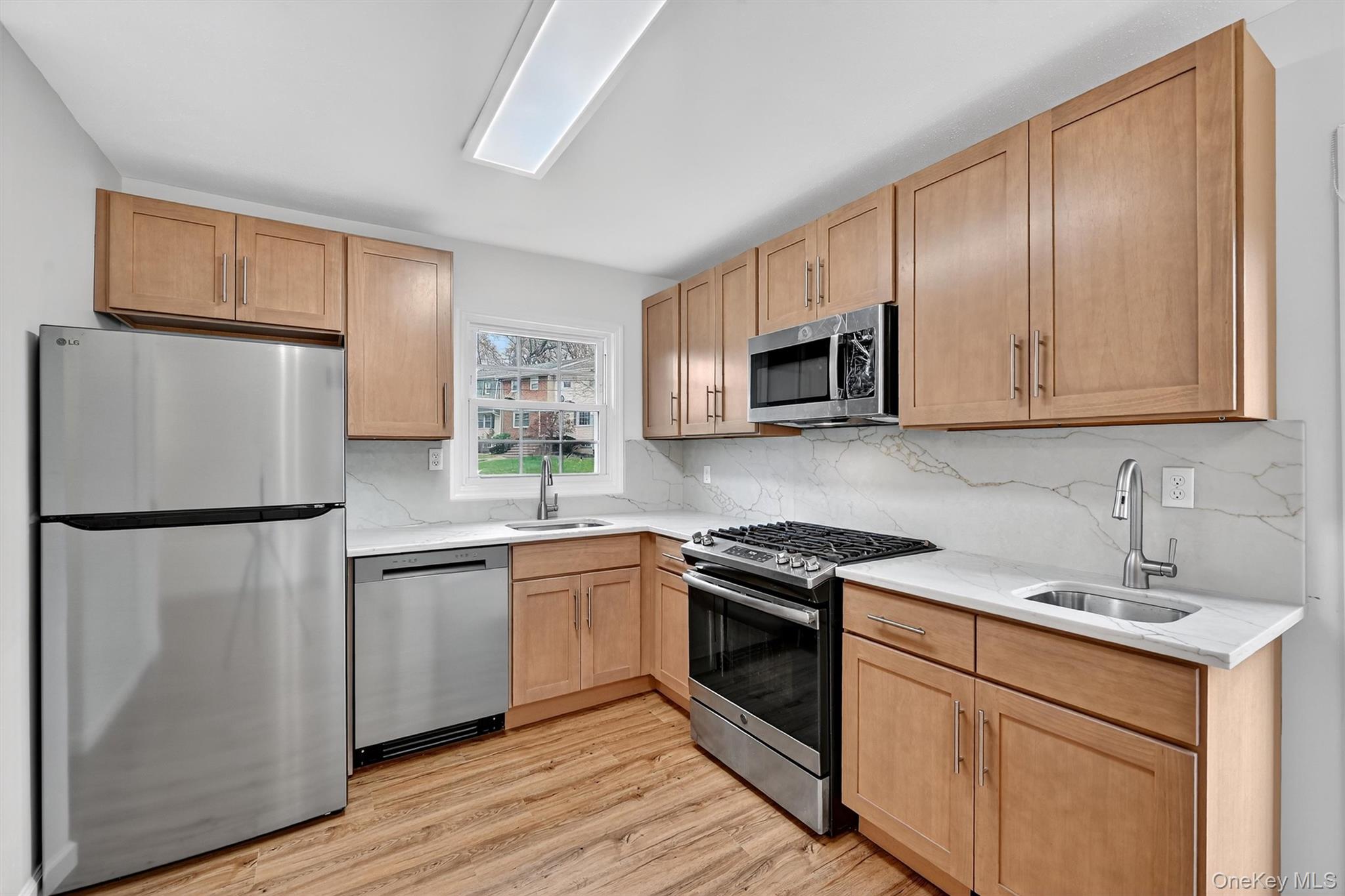 28 Alan Road Spring Valley, NY 10977 - Photo 10 of 39 a kitchen with a refrigerator sink and microwave