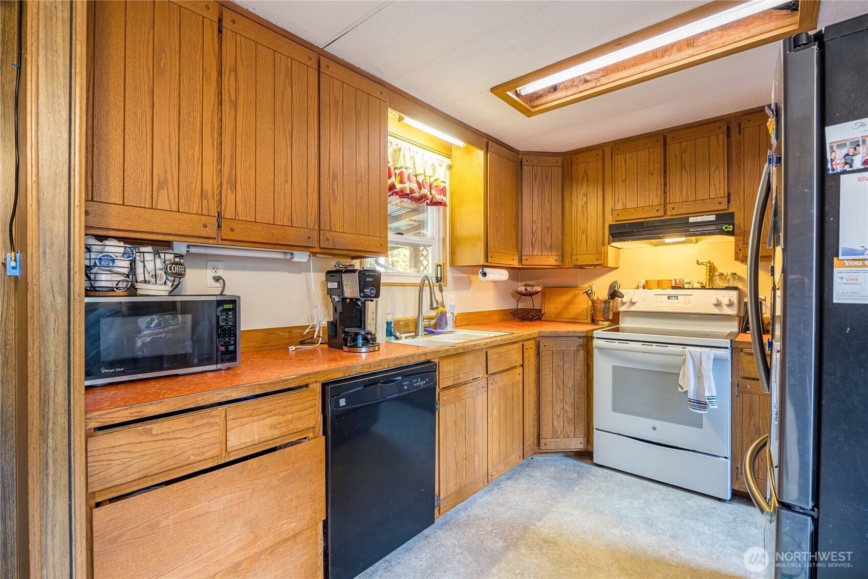 251 Gossett Road Port Angeles, WA 98363 - Photo 11 of 21 a kitchen with stainless steel appliances granite countertop a sink a stove and a refrigerator