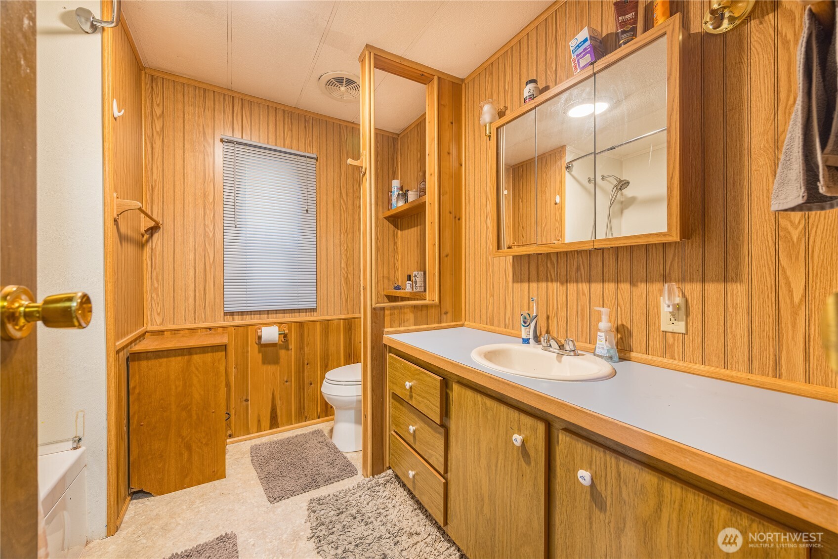 251 Gossett Road Port Angeles, WA 98363 - Photo 16 of 21 a bathroom with a sink mirror and a shower