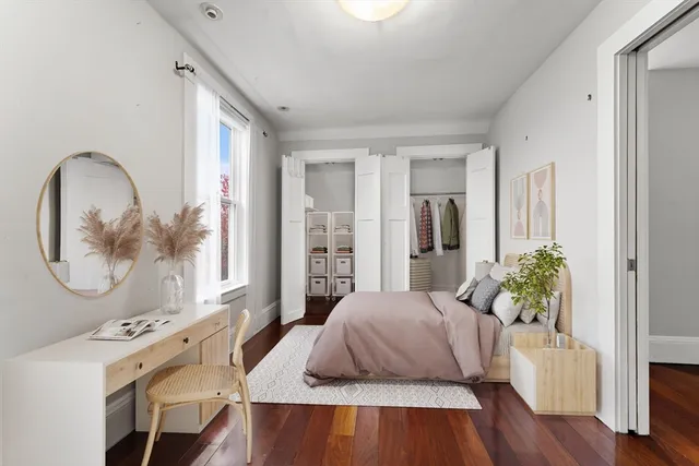 a living room with furniture and a mirror