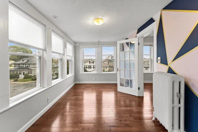 a view of an entryway with wooden floor and windows