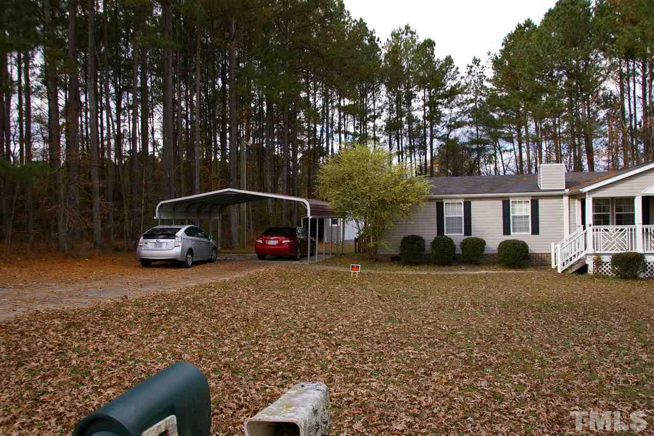 3539 Langston Road Raleigh, NC 27610 - Photo 2 of 4 a car parked in front of a house next to a yard