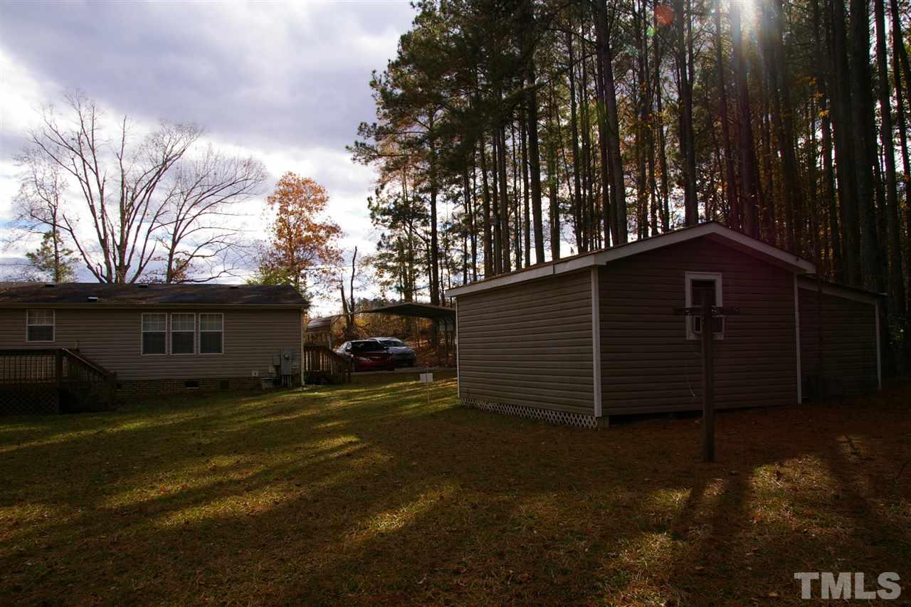 3539 Langston Road Raleigh, NC 27610 - Photo 3 of 4 a backyard of a house with barbeque oven and trees