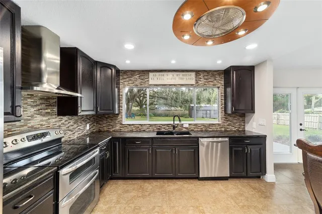a kitchen with stainless steel appliances granite countertop a stove and a sink