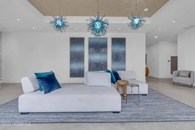 a large bed sitting in a room next to a chandelier