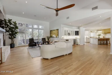 a kitchen with stainless steel appliances kitchen island granite countertop a table chairs sink and cabinets