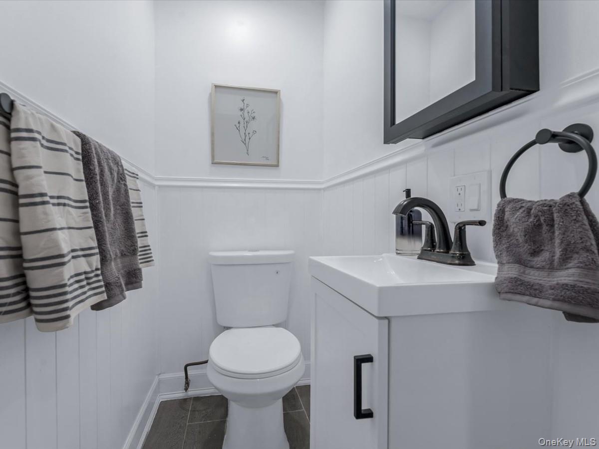 80-49 88th Avenue Queens, NY 11421 - Photo 14 of 28 a bathroom with a toilet sink and mirror