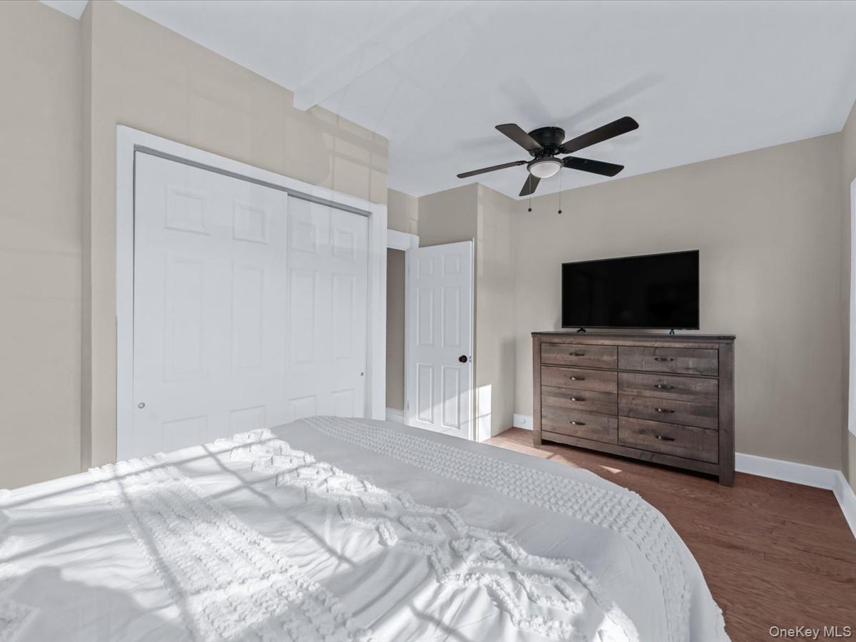 80-49 88th Avenue Queens, NY 11421 - Photo 17 of 28 a view of a livingroom with wooden floor and a ceiling fan