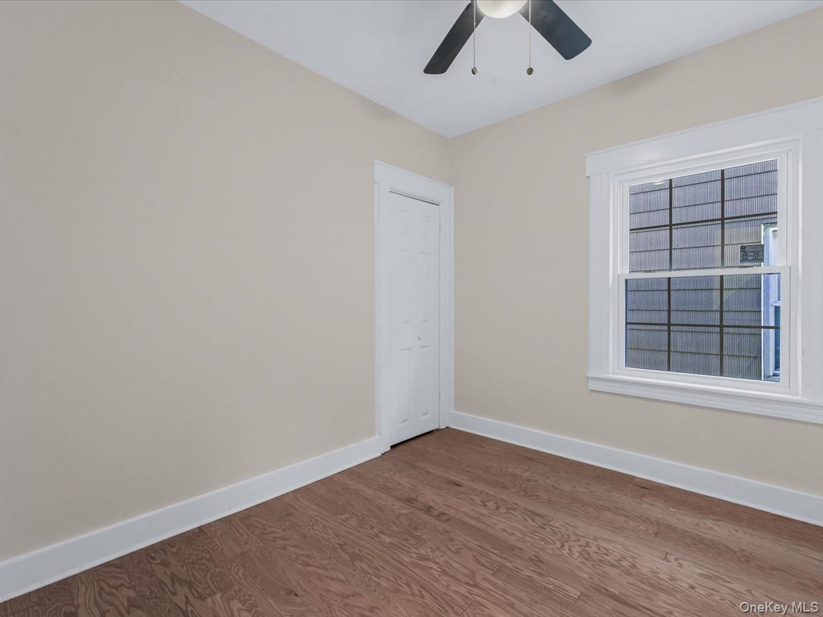 80-49 88th Avenue Queens, NY 11421 - Photo 18 of 28 an empty room with a window and a ceiling fan
