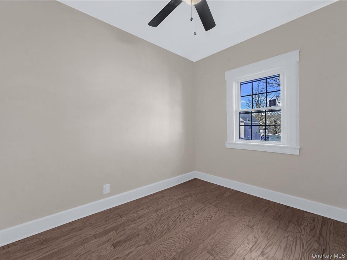 80-49 88th Avenue Queens, NY 11421 - Photo 19 of 28 an empty room with a window and ceiling fan