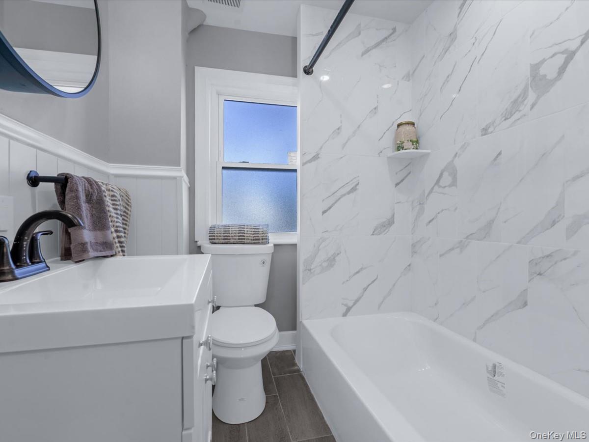 80-49 88th Avenue Queens, NY 11421 - Photo 20 of 28 a bathroom with a toilet a sink and bathtub