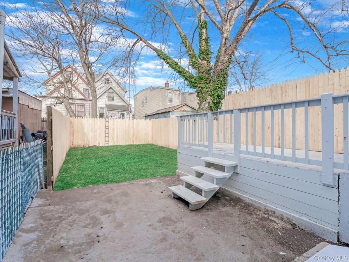 80-49 88th Avenue Queens, NY 11421 - Photo 27 of 28 a wooden bench sitting in middle of a yard