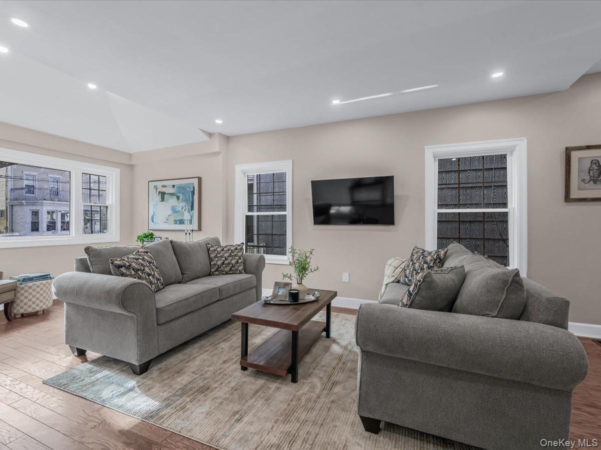 80-49 88th Avenue Queens, NY 11421 - Photo 4 of 28 a living room with furniture and a flat screen tv