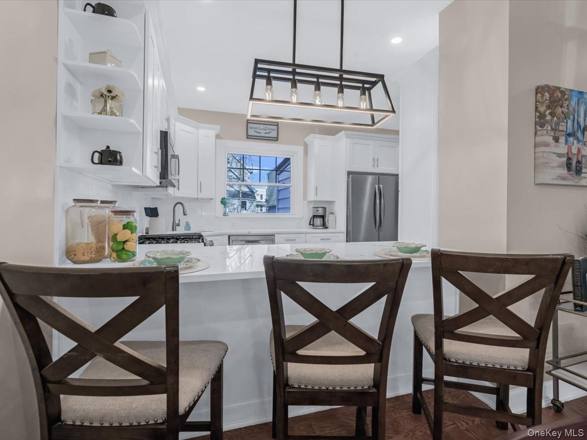 80-49 88th Avenue Queens, NY 11421 - Photo 10 of 28 a kitchen with a dining table and chairs
