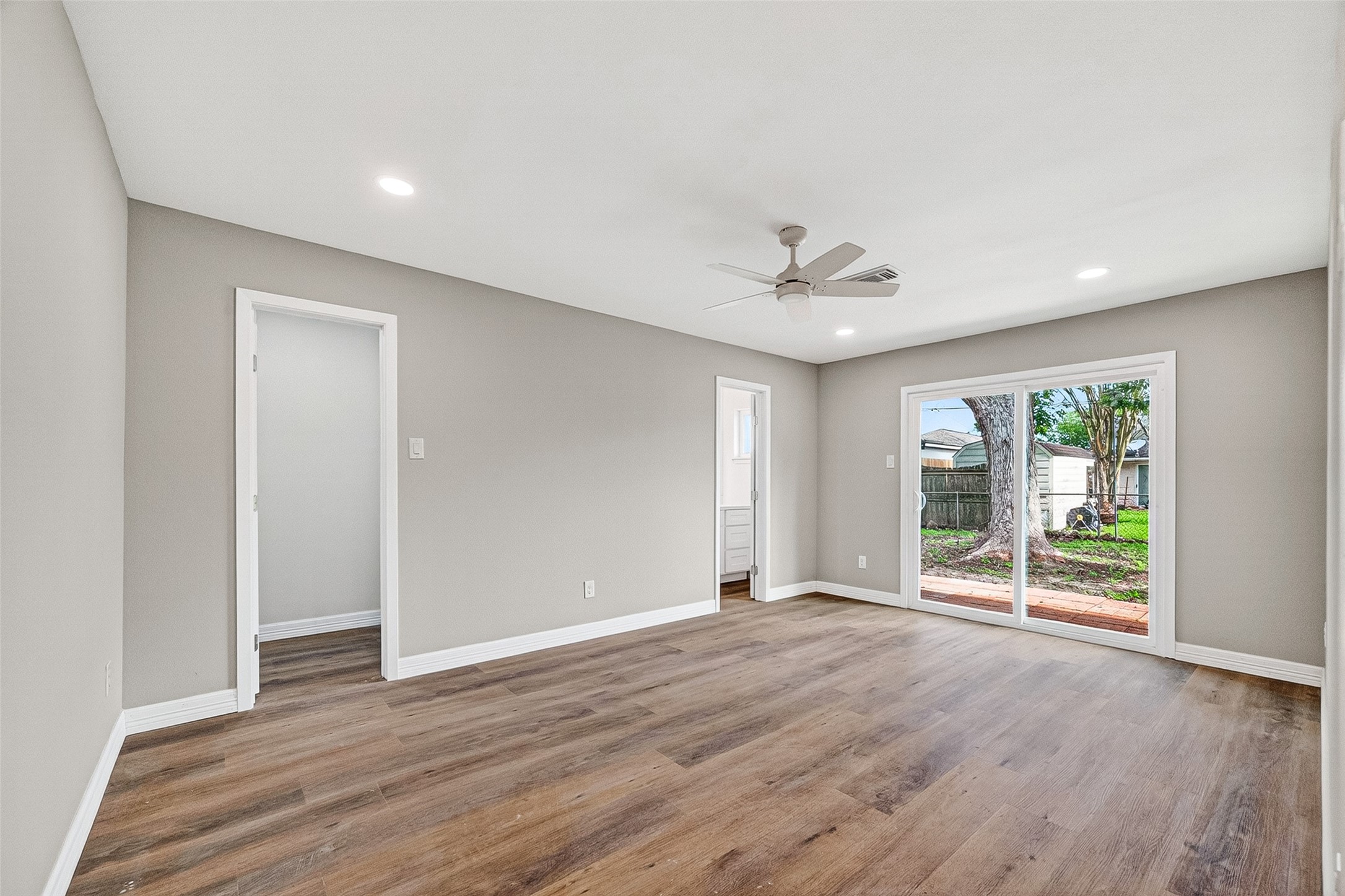 9723 Ebb Street Houston, TX 77089 - Photo 16 of 20 Primary bedroom with sliding doors to backyard and ensuite bathroom .