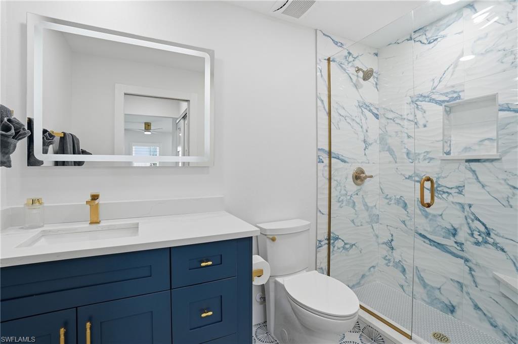 270 Dundee Road Fort Myers Beach, FL 33931 - Photo 23 of 48 Full bathroom with vanity and a marble finish shower - Virtually Edited Image