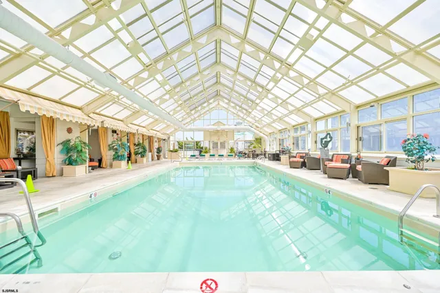 a view of swimming pool that has a two chairs in it