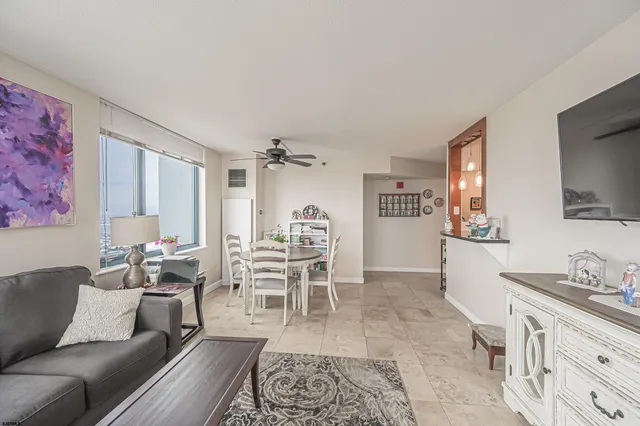 a living room with furniture wooden floor and a flat screen tv