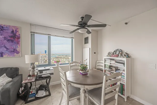 a view of a dining room with furniture and a chandelier