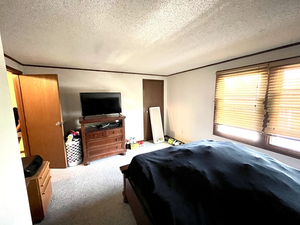 270 Sunderland Road, Unit 95 Worcester, MA 01604 - Photo 15 of 17 a bedroom with a bed and a flat screen tv