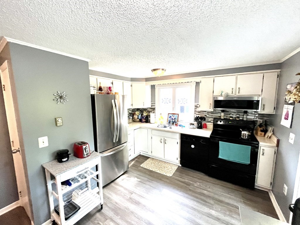 270 Sunderland Road, Unit 95 Worcester, MA 01604 - Photo 10 of 17 a kitchen with stainless steel appliances granite countertop a refrigerator stove and sink