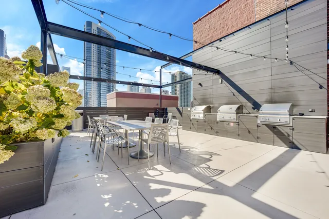 a view of a patio with table and chairs potted plants