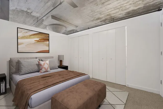 a bedroom with a bed and wall painting