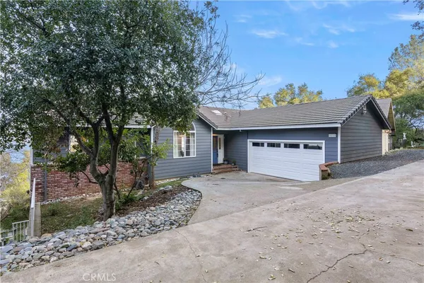 a view of a house with a yard and garage