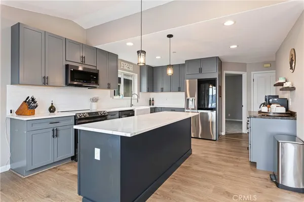 a stove top oven sitting inside of a kitchen