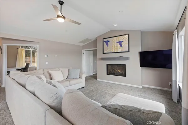 a living room with furniture a window and a fireplace