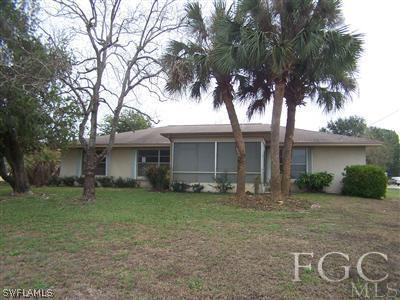 341 Delaware Road Lehigh Acres, FL 33936 - Photo 3 of 10 a view of a house with a yard