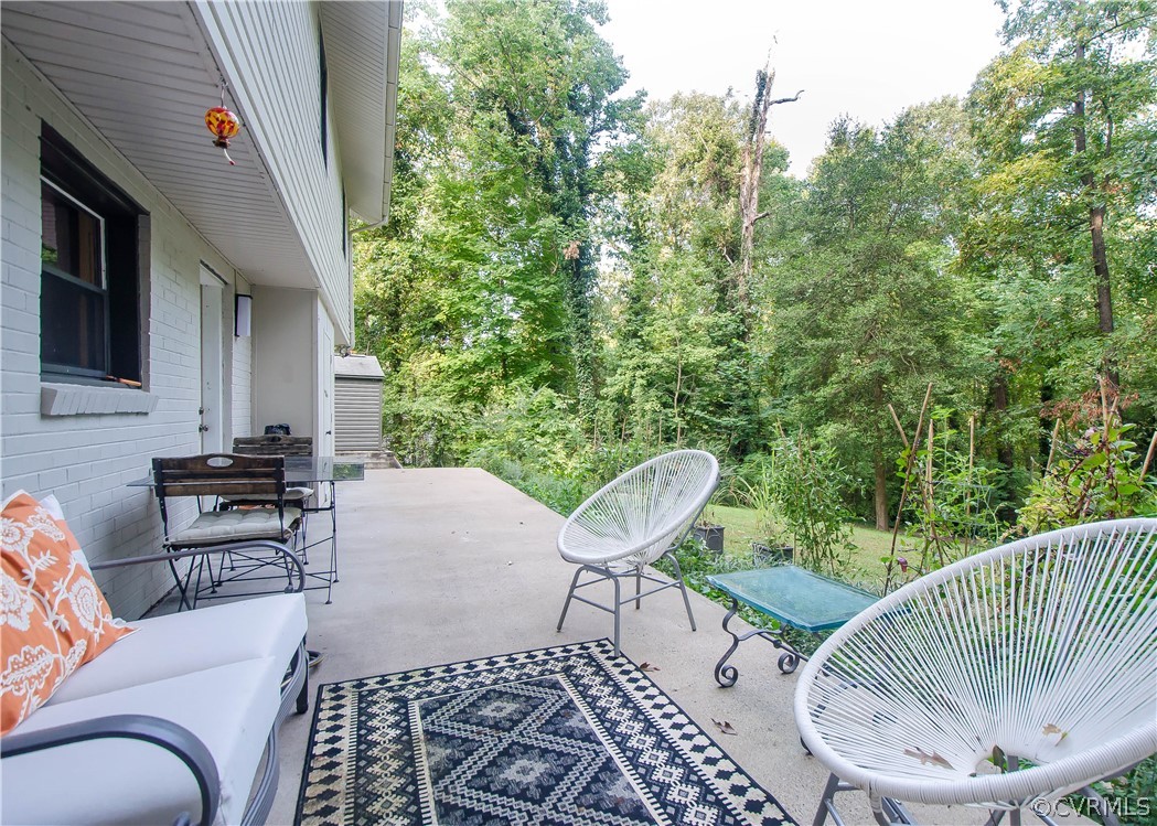 7638 Redbud Road Richmond, VA 23235 - Photo 28 of 32 The rear patio offers a serene view of the rear ya