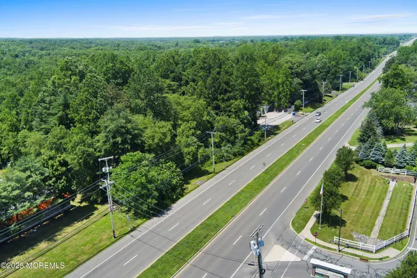 an aerial view of residential house with outdoor space and trees