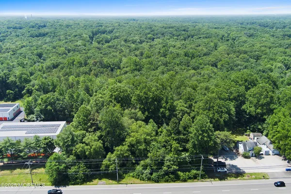 an aerial view of a houses with a yard