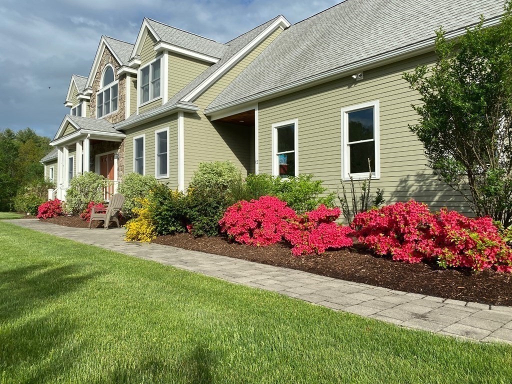 12 Cider Mill Road Stow, MA 01775 - Photo 1 of 42 a front view of white house with a yard and outdoor seating