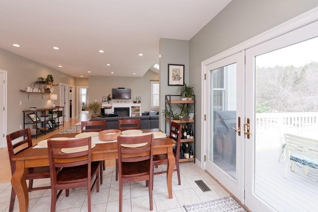 12 Cider Mill Road Stow, MA 01775 - Photo 11 of 42 a dining room with furniture and a floor to ceiling window