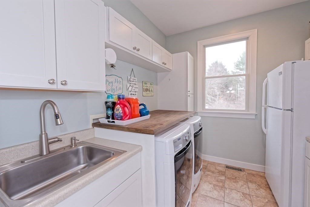 12 Cider Mill Road Stow, MA 01775 - Photo 18 of 42 a kitchen with a sink stove and refrigerator