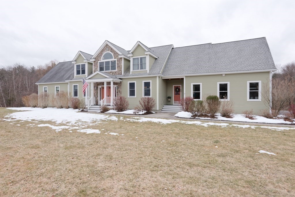 12 Cider Mill Road Stow, MA 01775 - Photo 2 of 42 a front view of a house with a yard