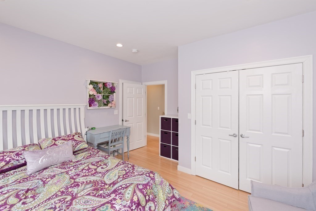 12 Cider Mill Road Stow, MA 01775 - Photo 23 of 42 a bedroom with a bed and wooden floor
