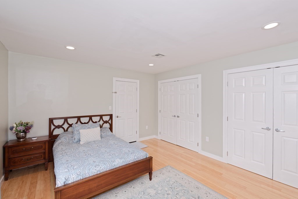 12 Cider Mill Road Stow, MA 01775 - Photo 24 of 42 a bedroom with a bed and wooden floor