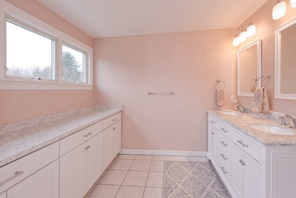 12 Cider Mill Road Stow, MA 01775 - Photo 30 of 42 a bathroom with a granite countertop sink a mirror and a window