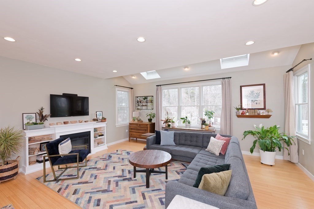 12 Cider Mill Road Stow, MA 01775 - Photo 5 of 42 a living room with furniture a flat screen tv and a fireplace