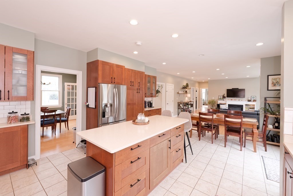 12 Cider Mill Road Stow, MA 01775 - Photo 6 of 42 a kitchen with stainless steel appliances kitchen island granite countertop a table chairs sink and cabinets