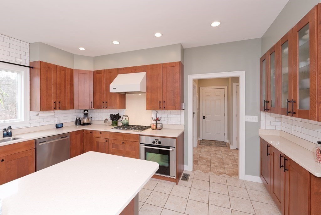 12 Cider Mill Road Stow, MA 01775 - Photo 8 of 42 a kitchen with a sink a stove and cabinets