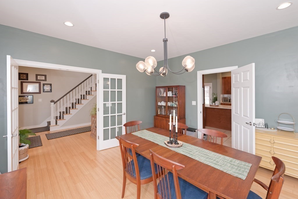 12 Cider Mill Road Stow, MA 01775 - Photo 10 of 42 a view of a dining room with furniture a chandelier and wooden floor